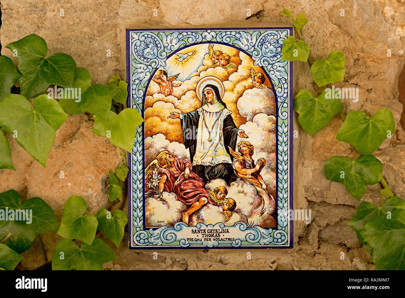 Painted tile, picture of a saint on a house wall, Valldemossa, Majorca, Spain Stock Photo