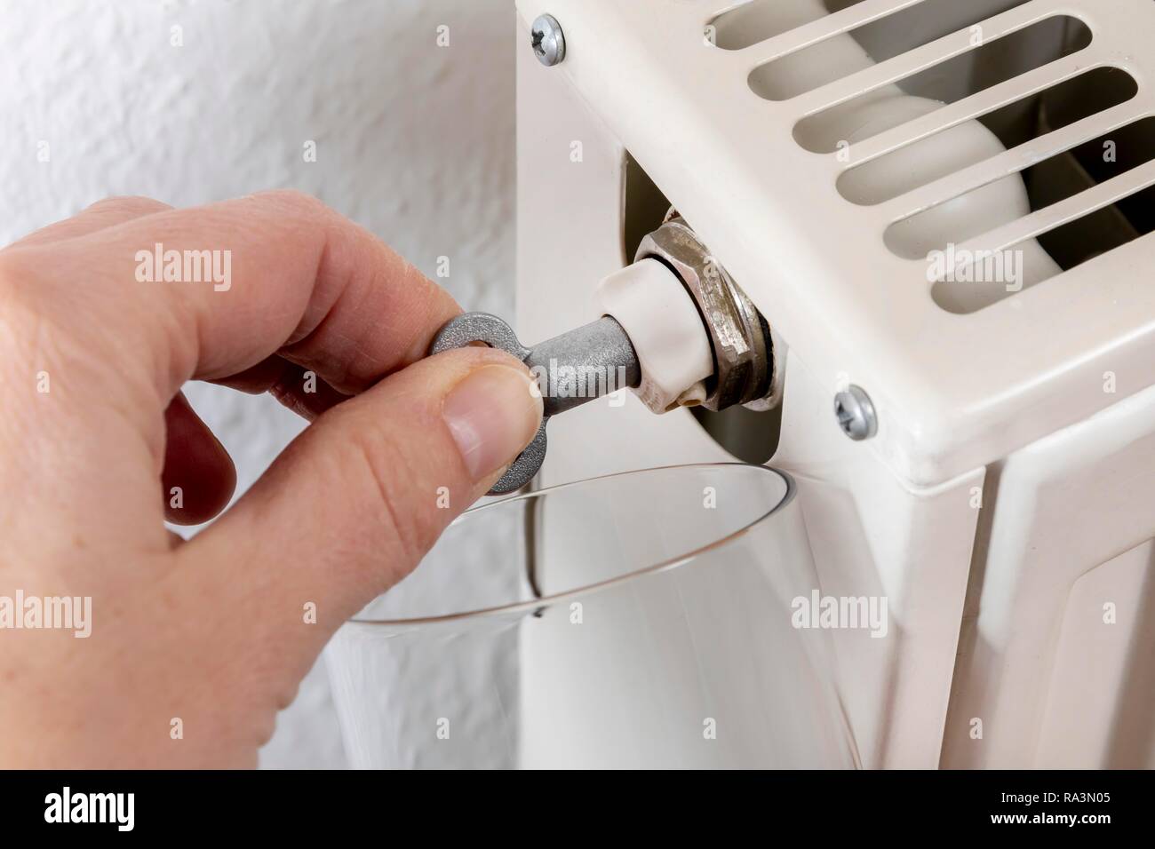 Hand venting a radiator with a special key, Bavaria, Germany Stock Photo