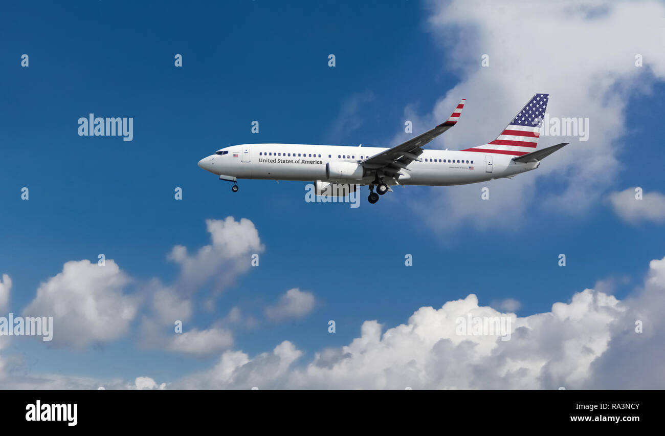Custom commercial passenger aircraft with american flag on the tail. Commercial aircraft with flag on the tail and fuselage landing at an airport. Stock Photo