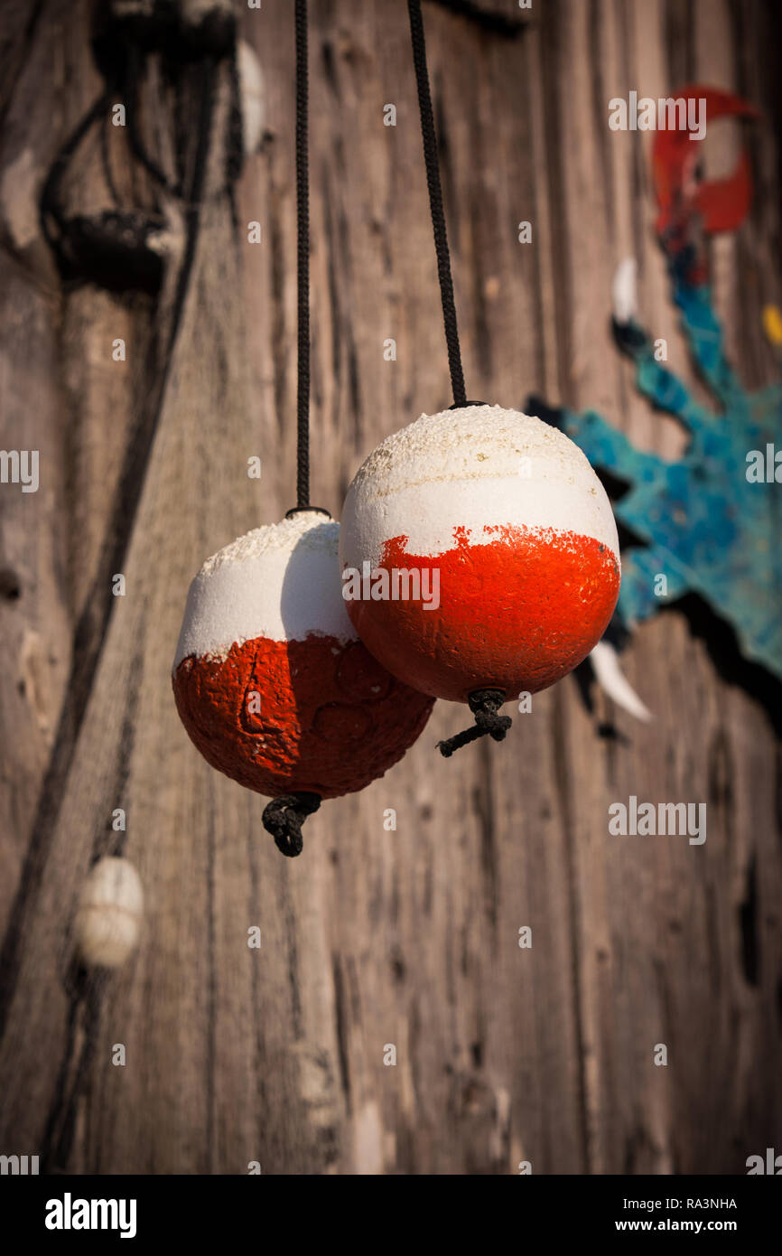 two red and white fishing markers, buoys, hang to dry Stock Photo Alamy