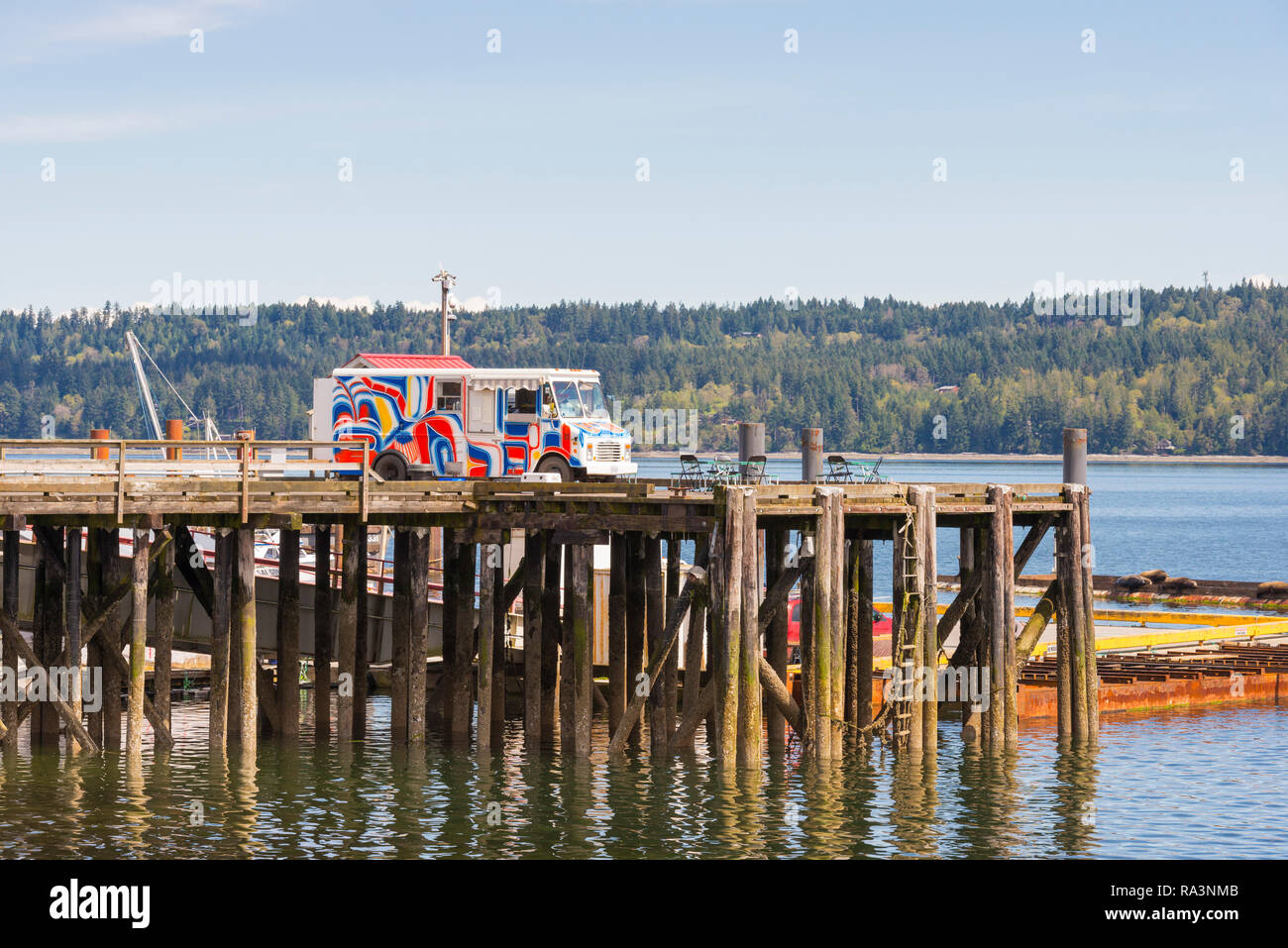 A colourful van selling fast food at a dock on Vancouver Island Stock Photo