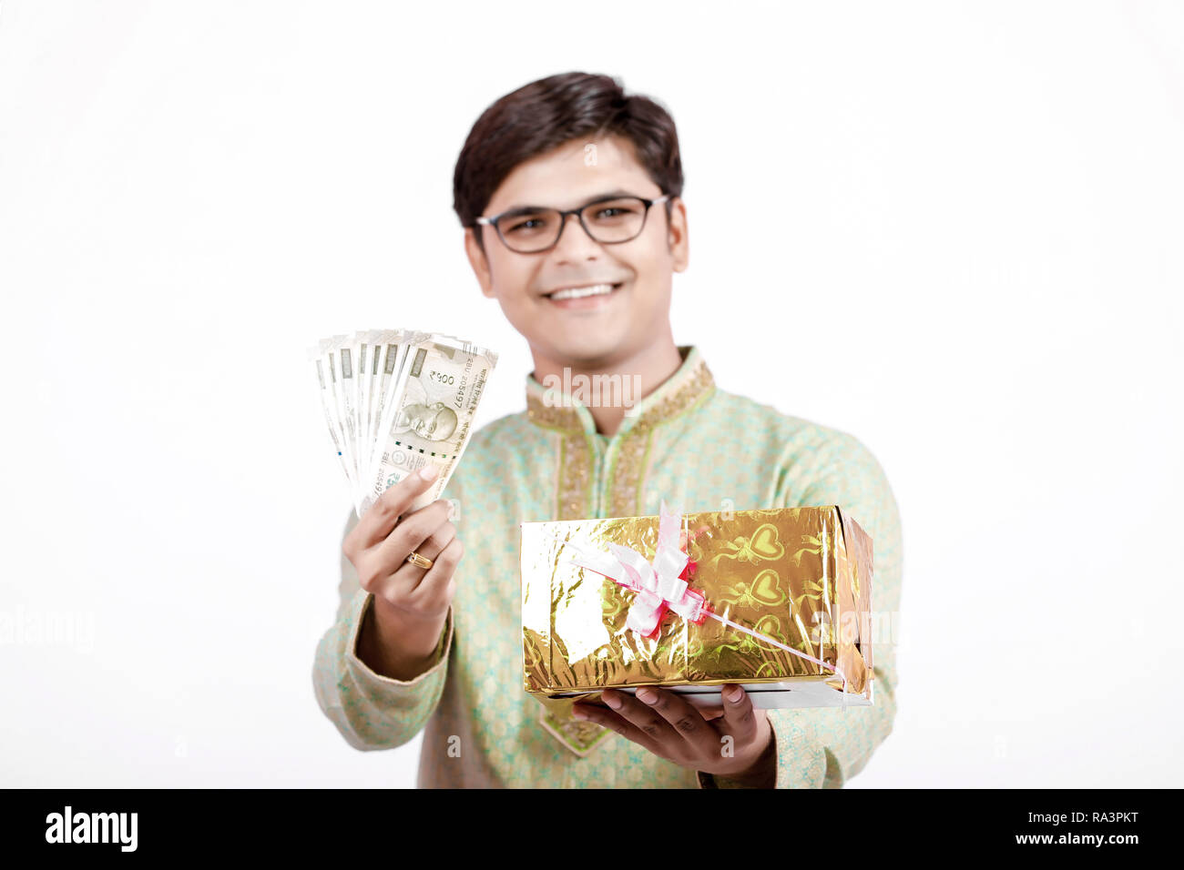 Indian man holding Indian currency note and gift in hand Stock Photo