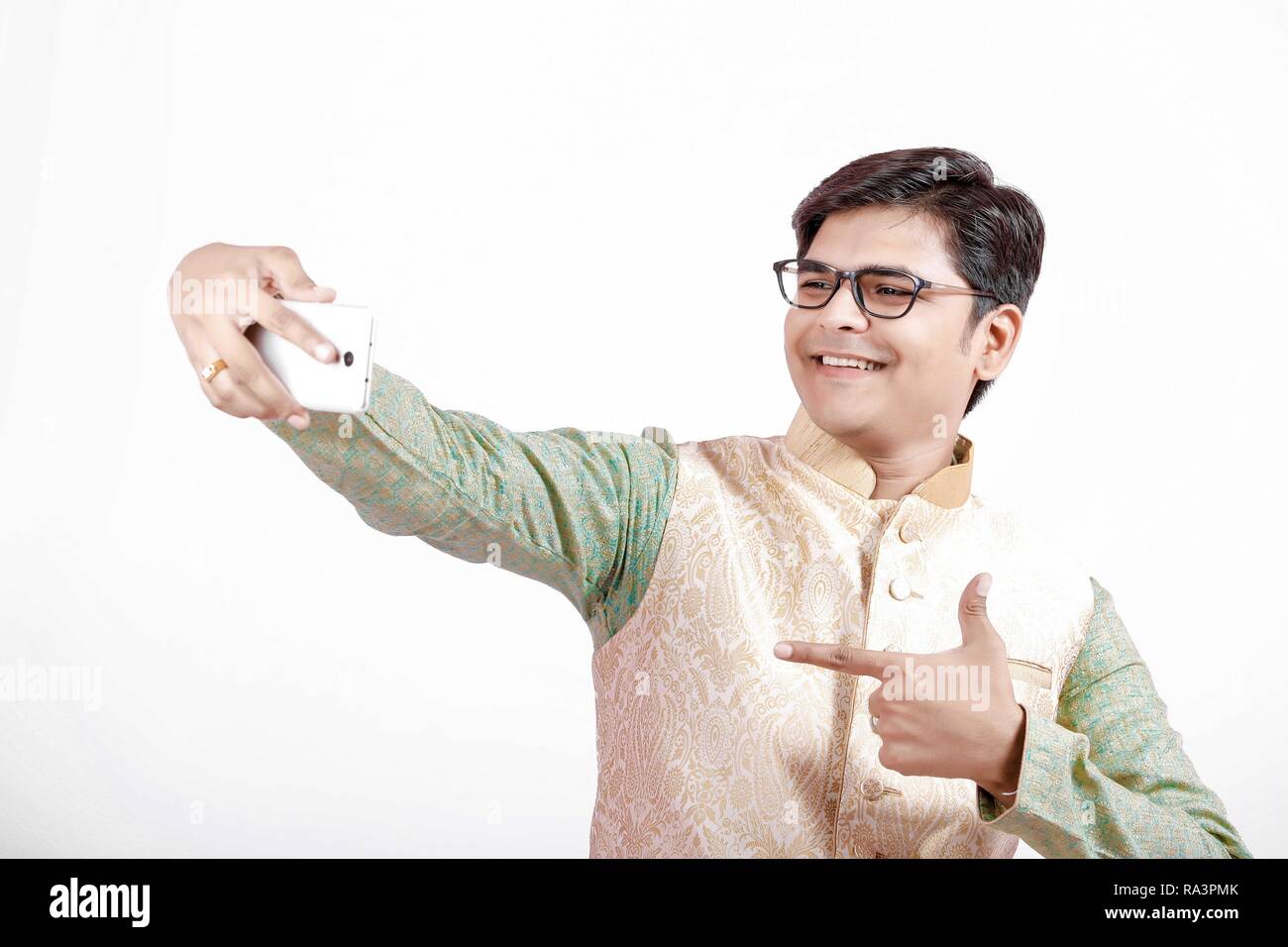 young Indian man taking selfie with mobile Stock Photo