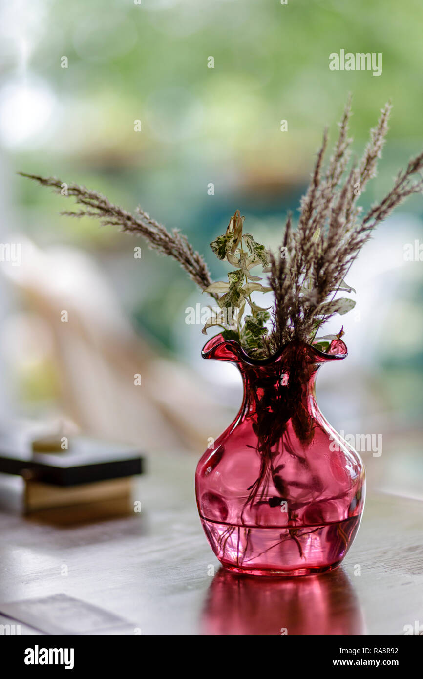A small rose-colored vase with native flowers Stock Photo