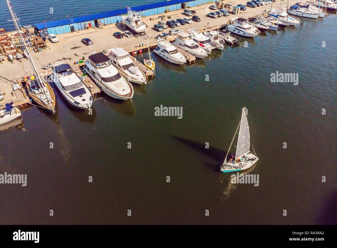 Yachts parking in harbor at sunset, Harbor yacht club Stock Photo - Alamy