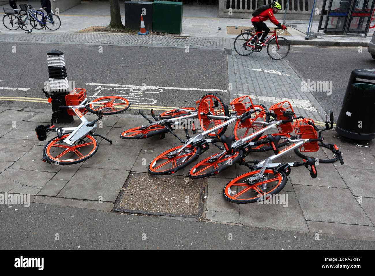 A selection of Mobike's pictured knocked over on the floor in London, UK. Stock Photo