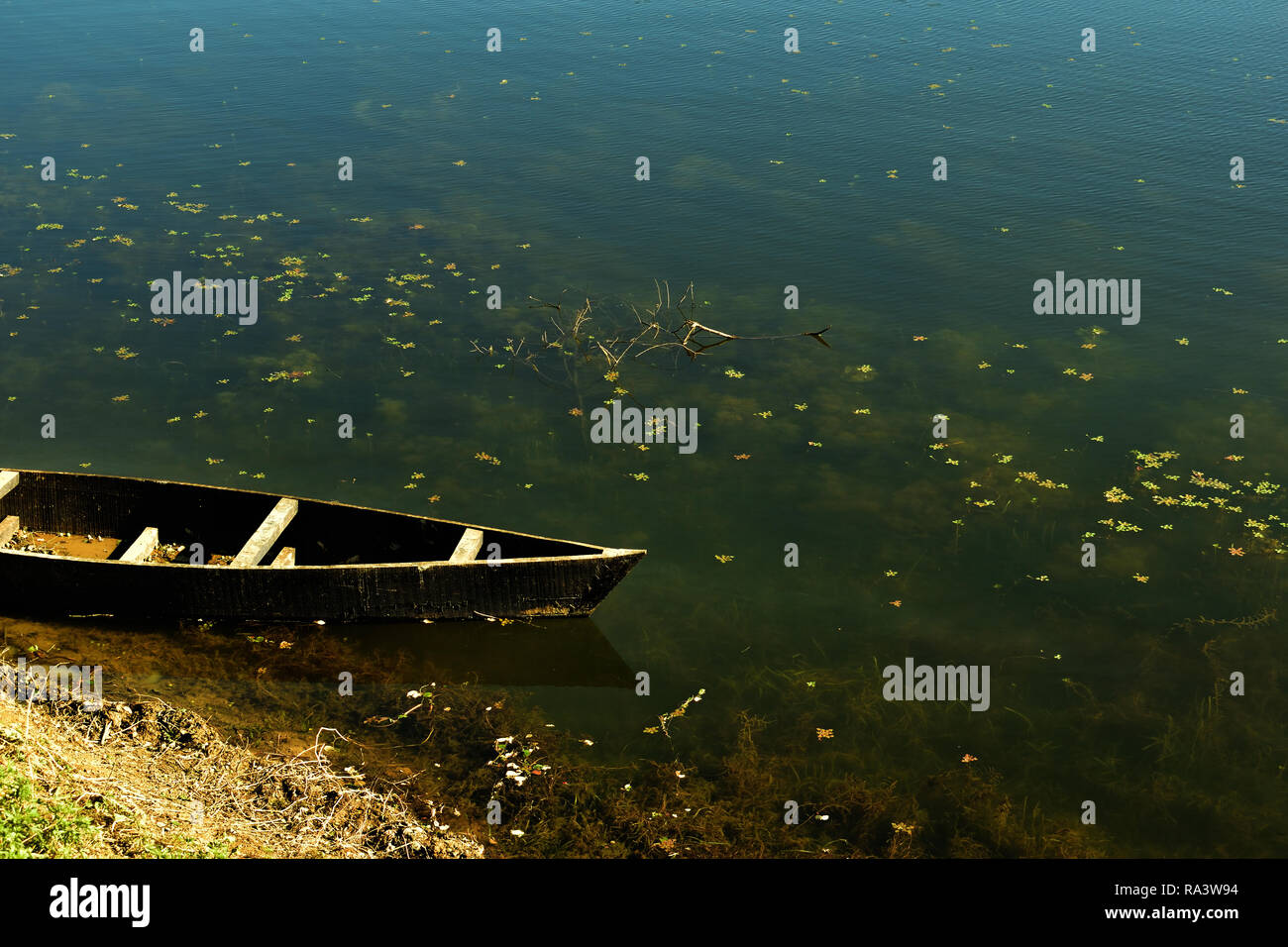 A Boat standing near a bank of a beautiful lake Stock Photo - Alamy