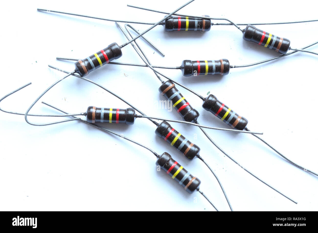 A heap of multicolored brown resistors with 180 KOhm resistance and 1 Watt power dissipation, with axial horizontal through hole mount, with pins Stock Photo