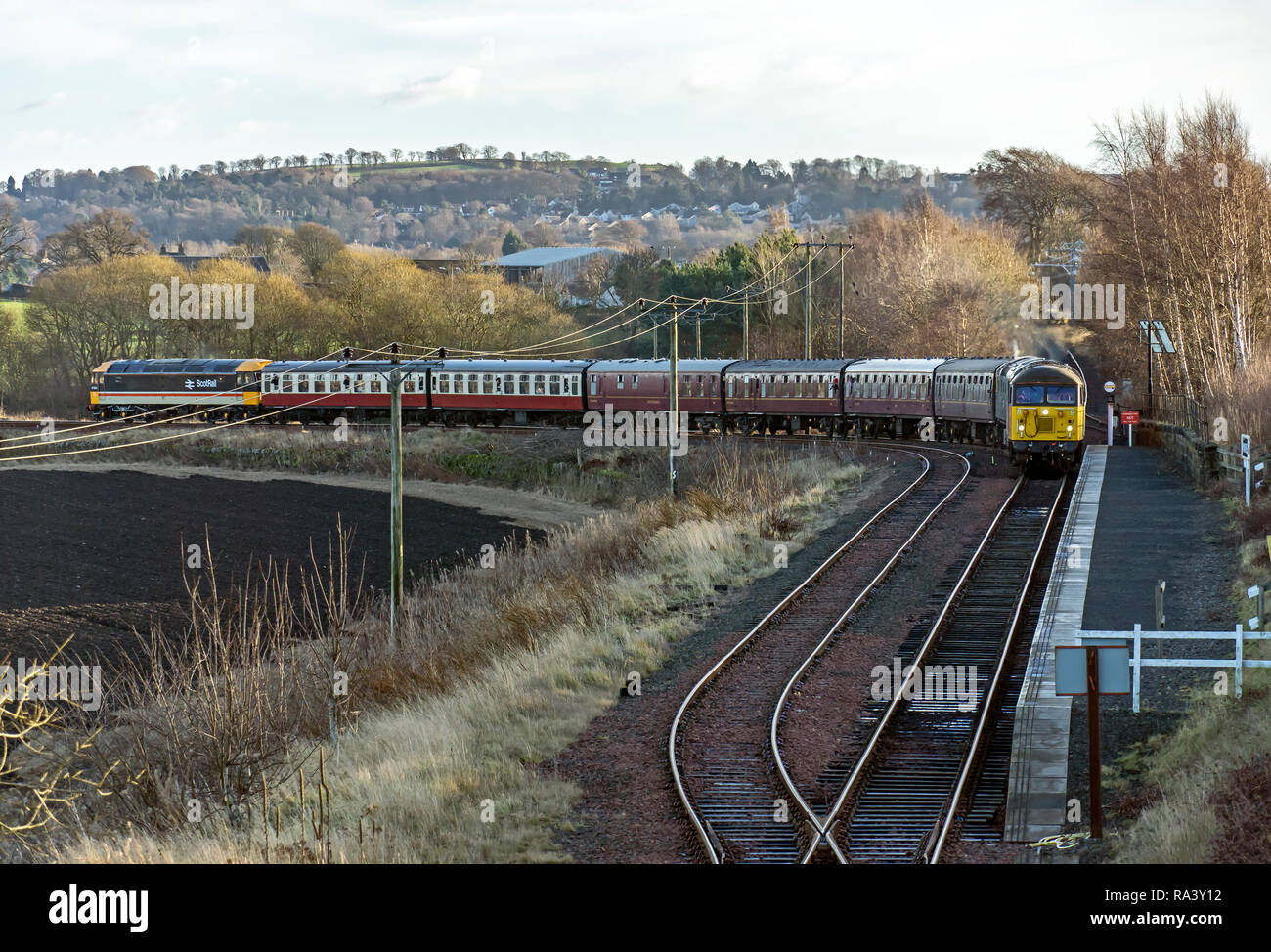 Passenger train with diesel engines 47643 front and 27001 & Class 56 Colas leaving Manuel  winter diesel gala at Bo'ness & Kinneil Railway in Bo'ness Stock Photo