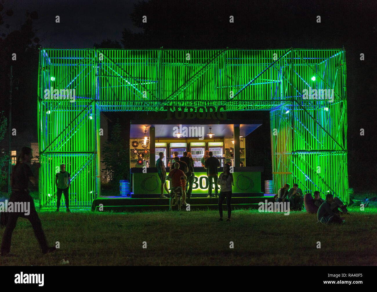 KIEV, UKRAINE - JULY 05, 2018: People enjoy live concert and visit night Tuborg beer bar at the Atlas Weekend Festival in National Expocenter. Stock Photo