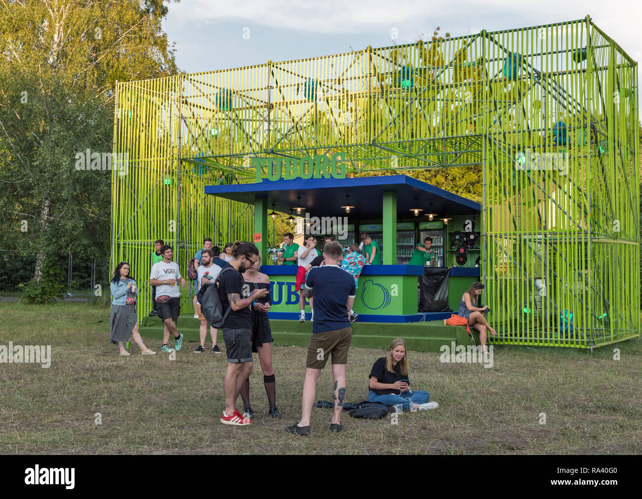 KIEV, UKRAINE - JULY 06, 2018: People enjoy live concert and visit outdoor Tuborg beer bar at the Atlas Weekend Festival in National Expocenter. Stock Photo