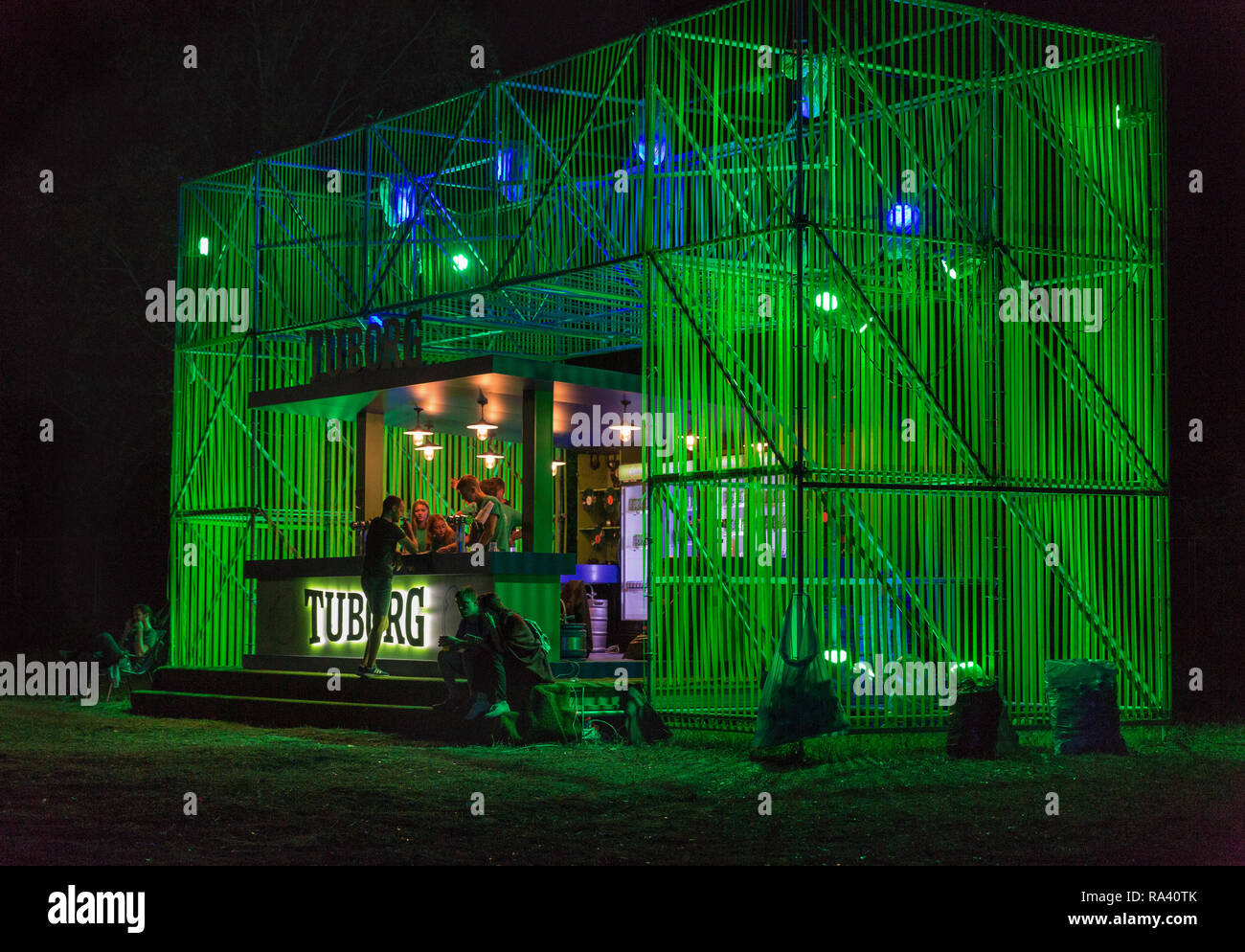 KIEV, UKRAINE - JULY 08, 2018: People enjoy live concert and visit night Tuborg beer bar at the Atlas Weekend Festival in National Expocenter. Stock Photo