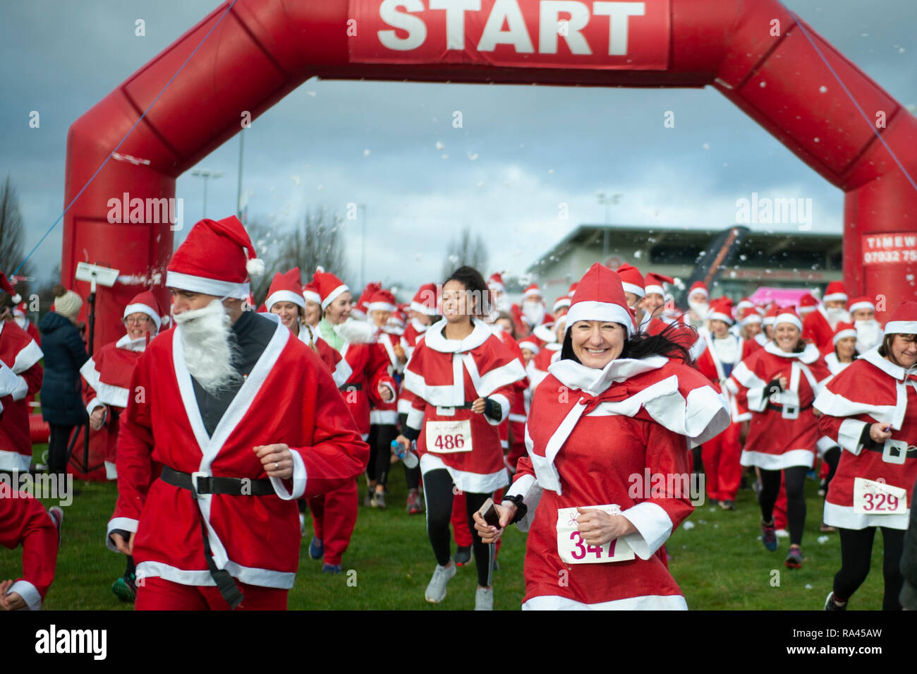 Moseley Rugby Club, Billesley Common, Birmingham, West Midlands, UK. 2nd December 2018.  Hundreds of generous-hearted Santas take part in a mass run t Stock Photo
