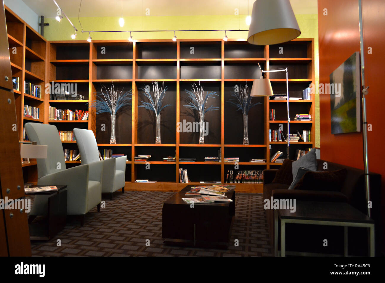 Lobby seating area with bookshelves in a modern mixeduse residential