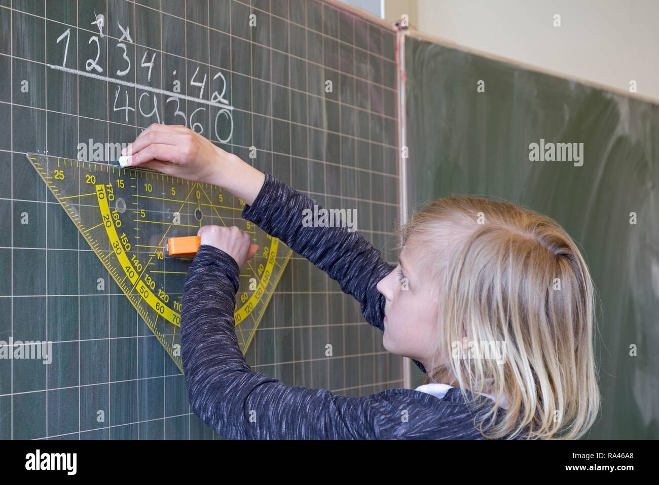 Student calculating on the blackboard, mathematics lessons , primary school, Lower Saxony, Germany Stock Photo