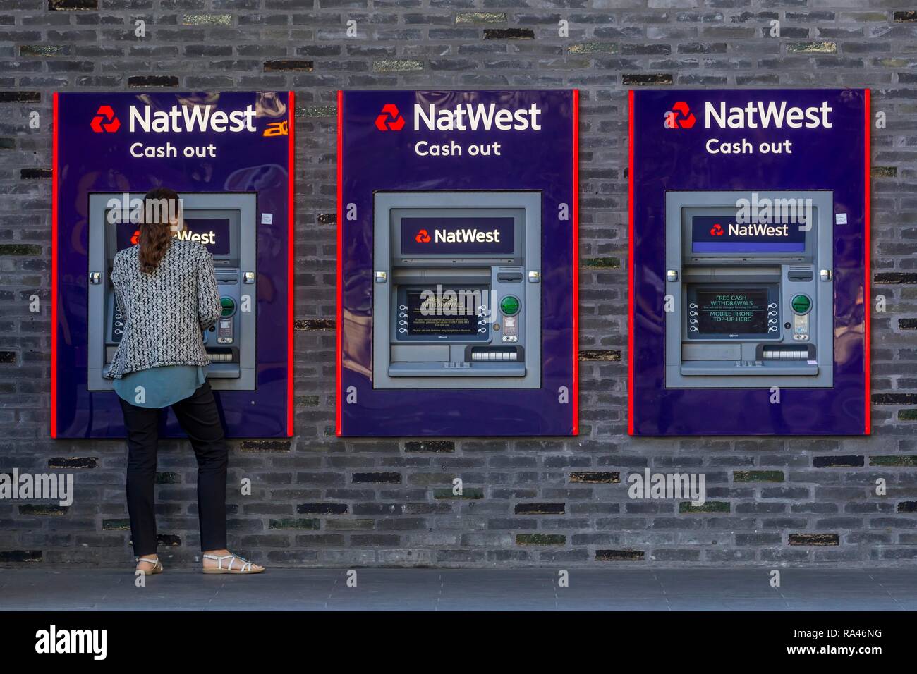 Woman at the cash dispenser of NatWest Bank, London, Great Britain Stock Photo