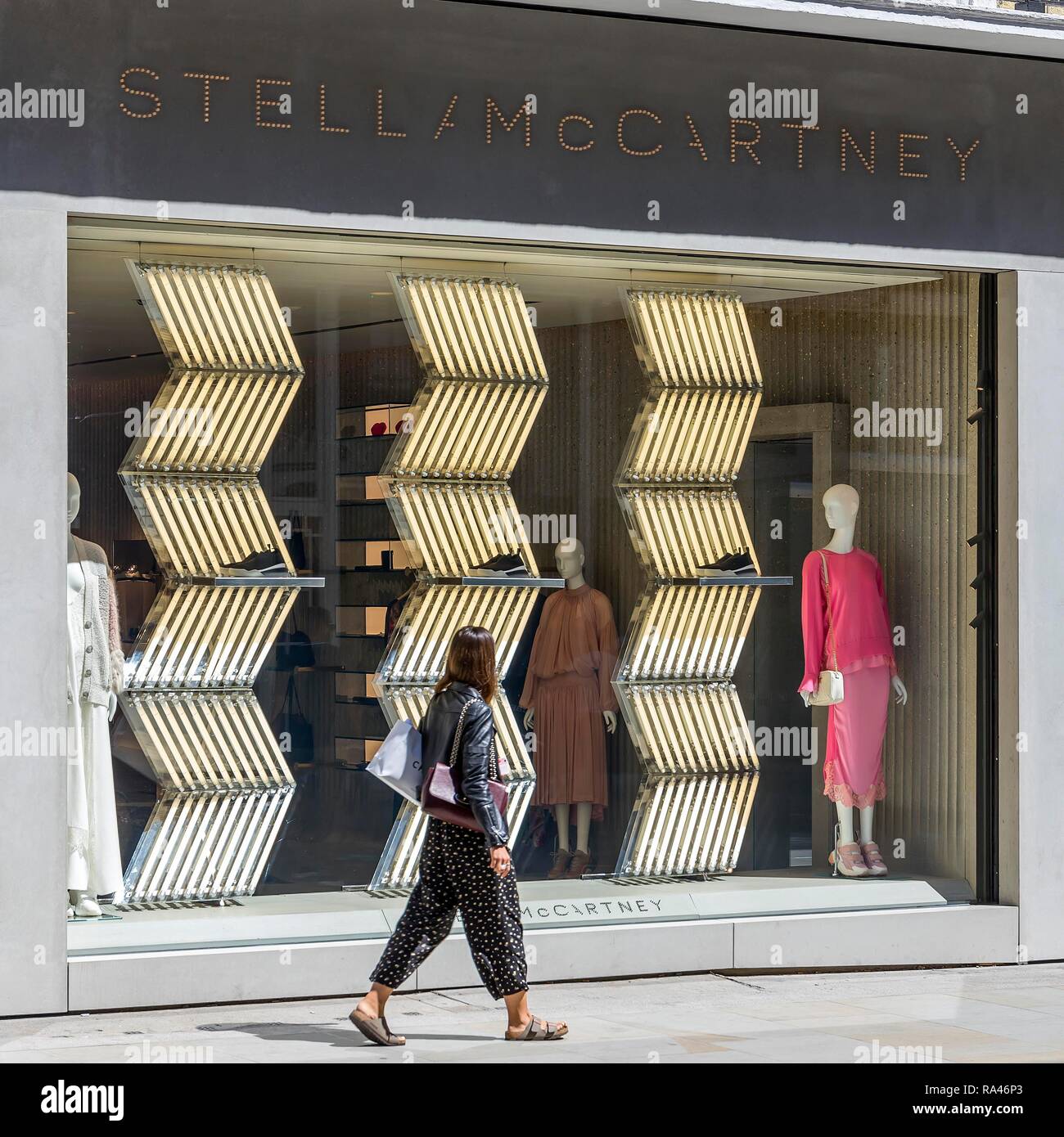 Passer-by in front of shop window, fashion shop Stella Mc Cartney, London, United Kingdom Stock Photo