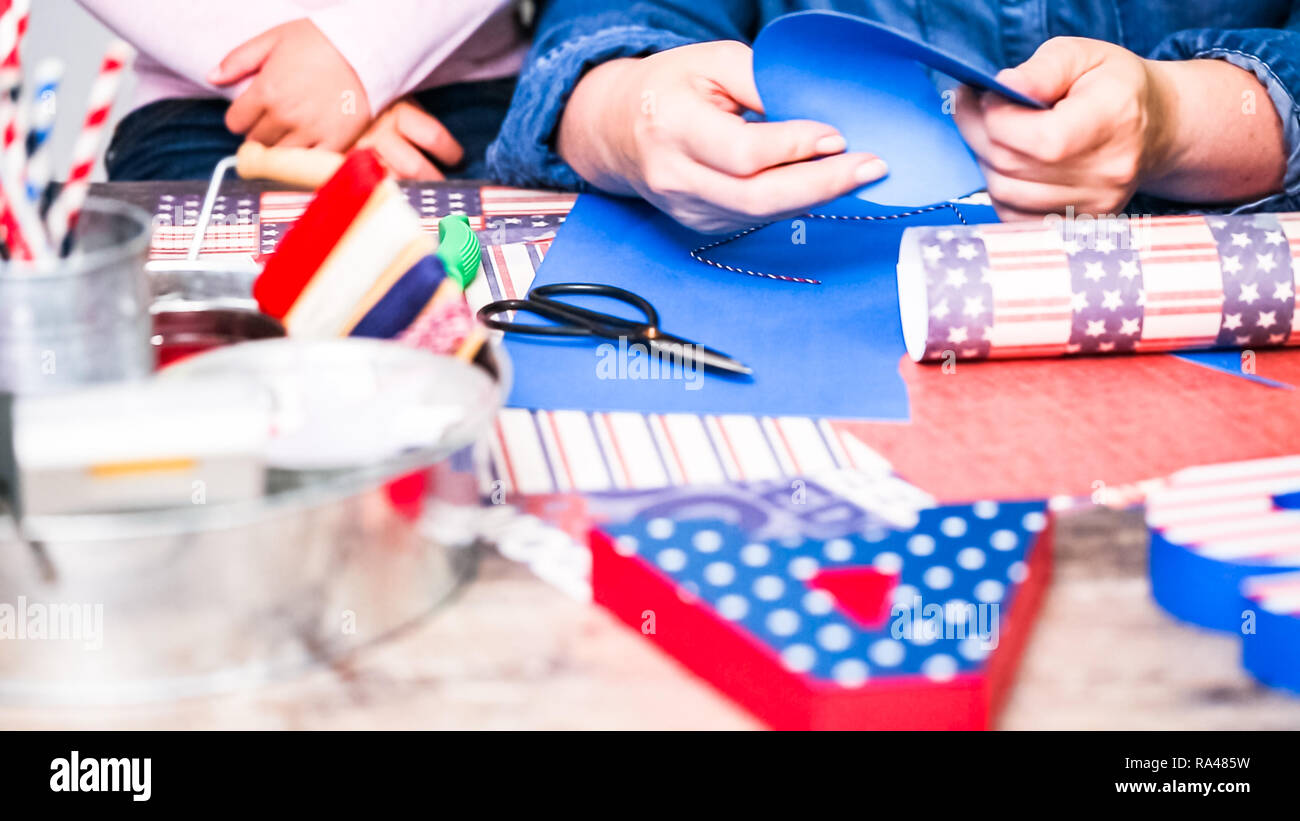 Step by step. Mother and daughter making paper firecrackers for July ...