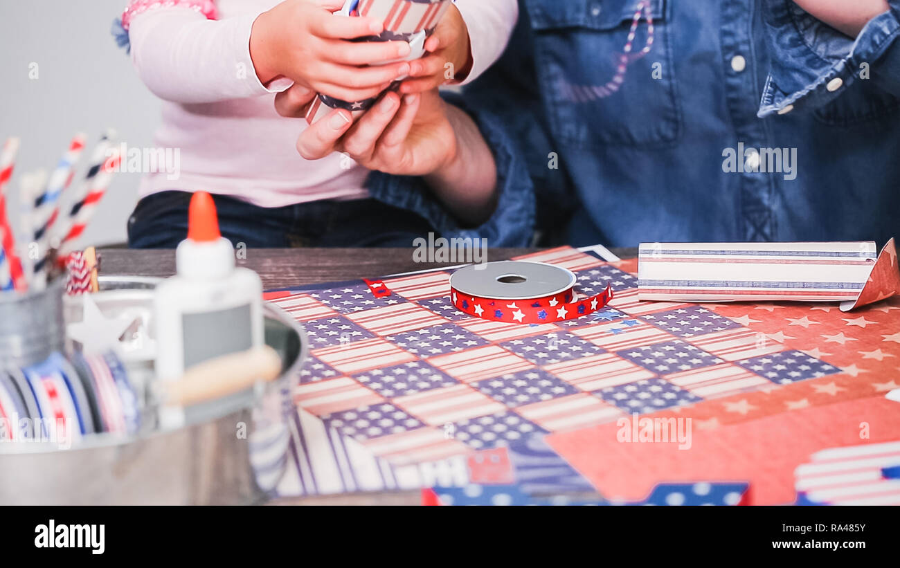 Step by step. Mother and daughter making paper firecrackers for July ...