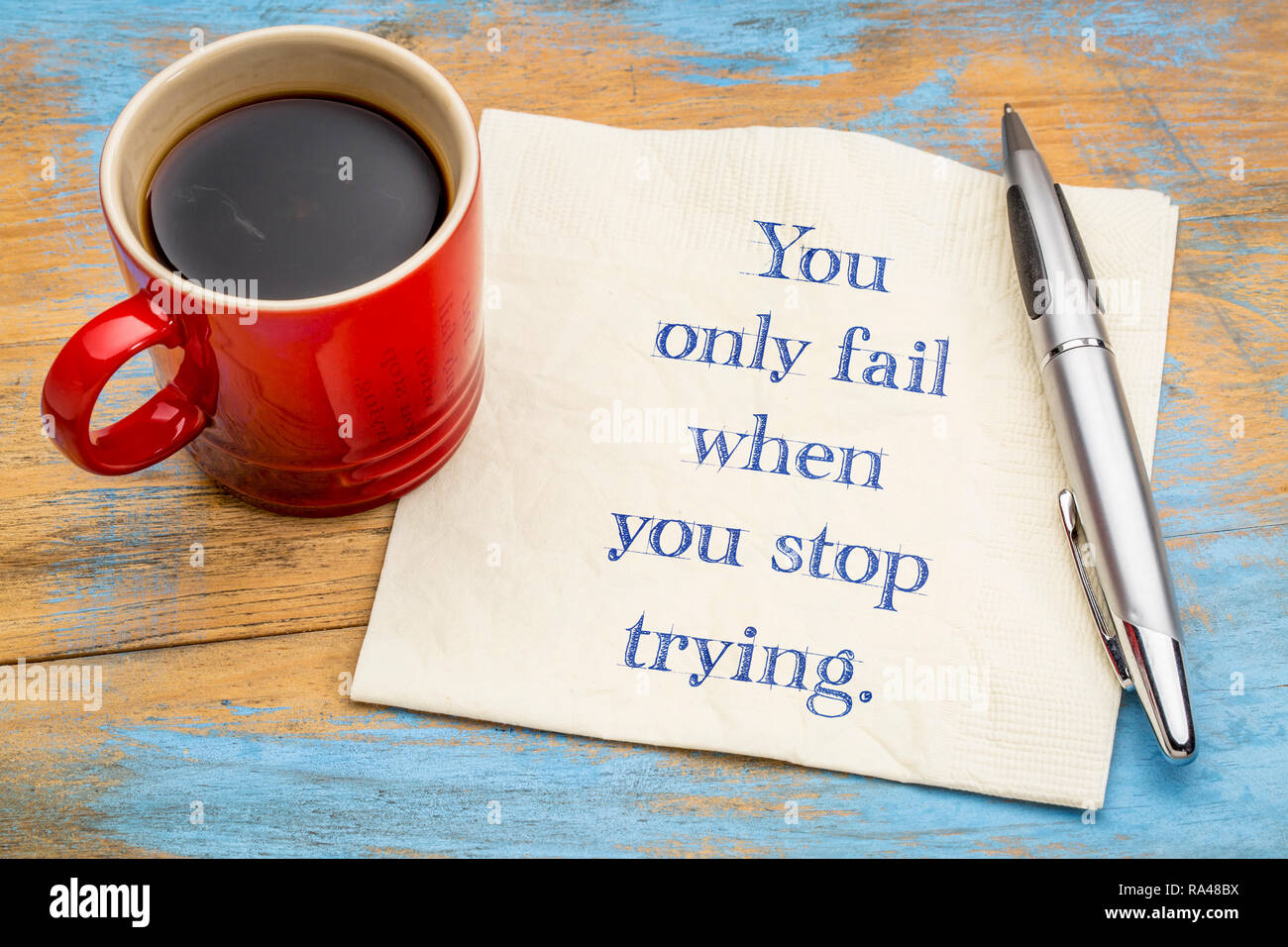 You only fail when you stop trying - handwriting on a napkin with a cup of coffee Stock Photo