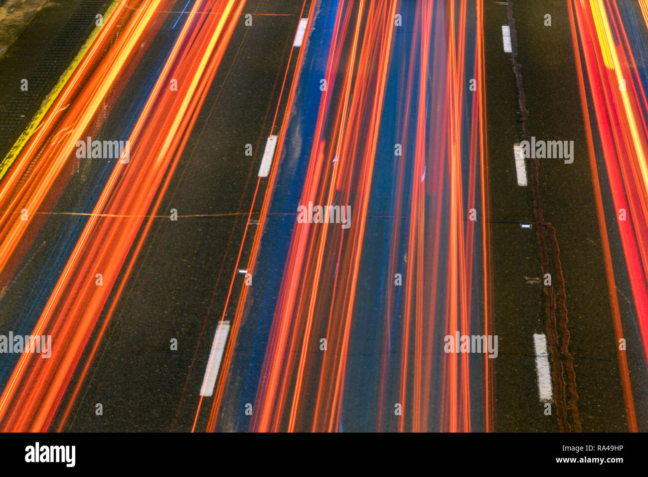 Long exposure of a motorway traffic at night - light trails painted in the shot. Stock Photo