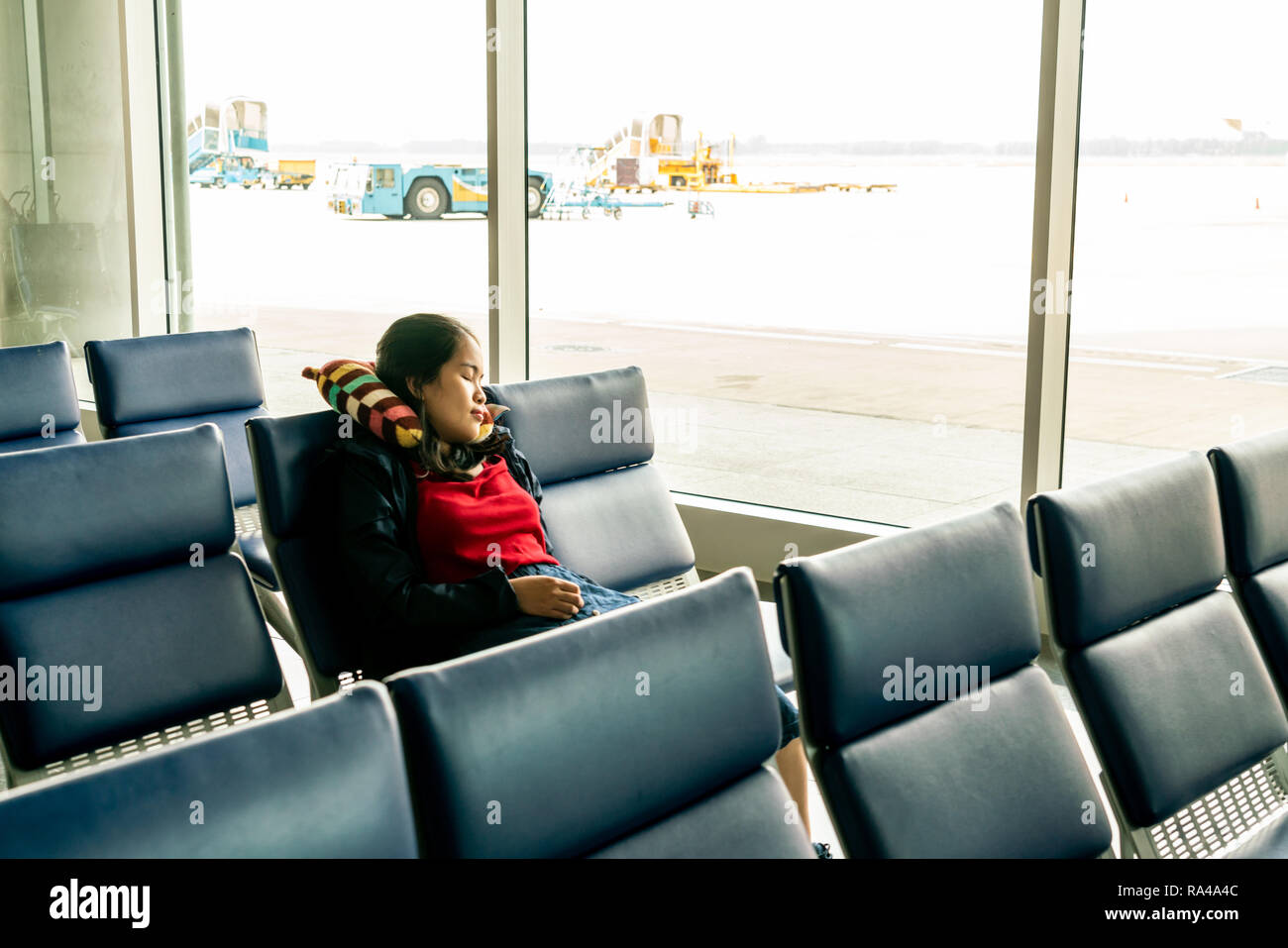 Tired woman sleeping airport hi-res stock photography and images - Alamy