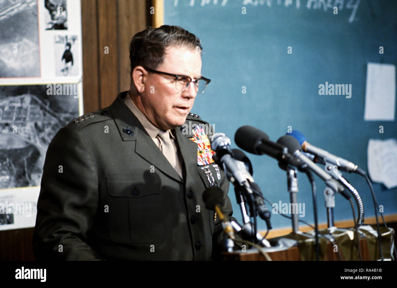 1975 - Commandant of the Marine Corps General Robert E. Cushman Jr. speaks after touring temporary housing facilities erected for Vietnamese refugees. Stock Photo