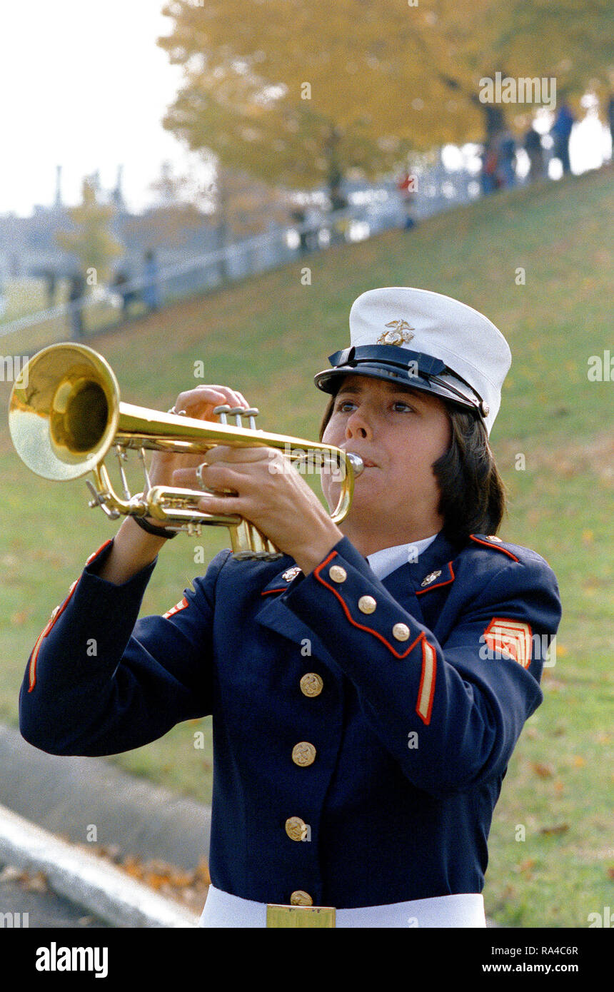 1979 - A woman Marine sergeant, who is a member of the band blows her trumpet, during a Marine Corps Birthday Pageant held in the stadium. Stock Photo