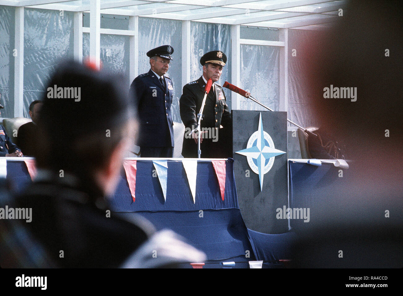 GEN Alexander M. Haig, commander of NATO forces in Europe, delivers a welcoming speech during the arrival ceremony for 16 F-111 pilots and their aircraft. MGEN Evan W. Rosecrans waits for his turn to speak Stock Photo