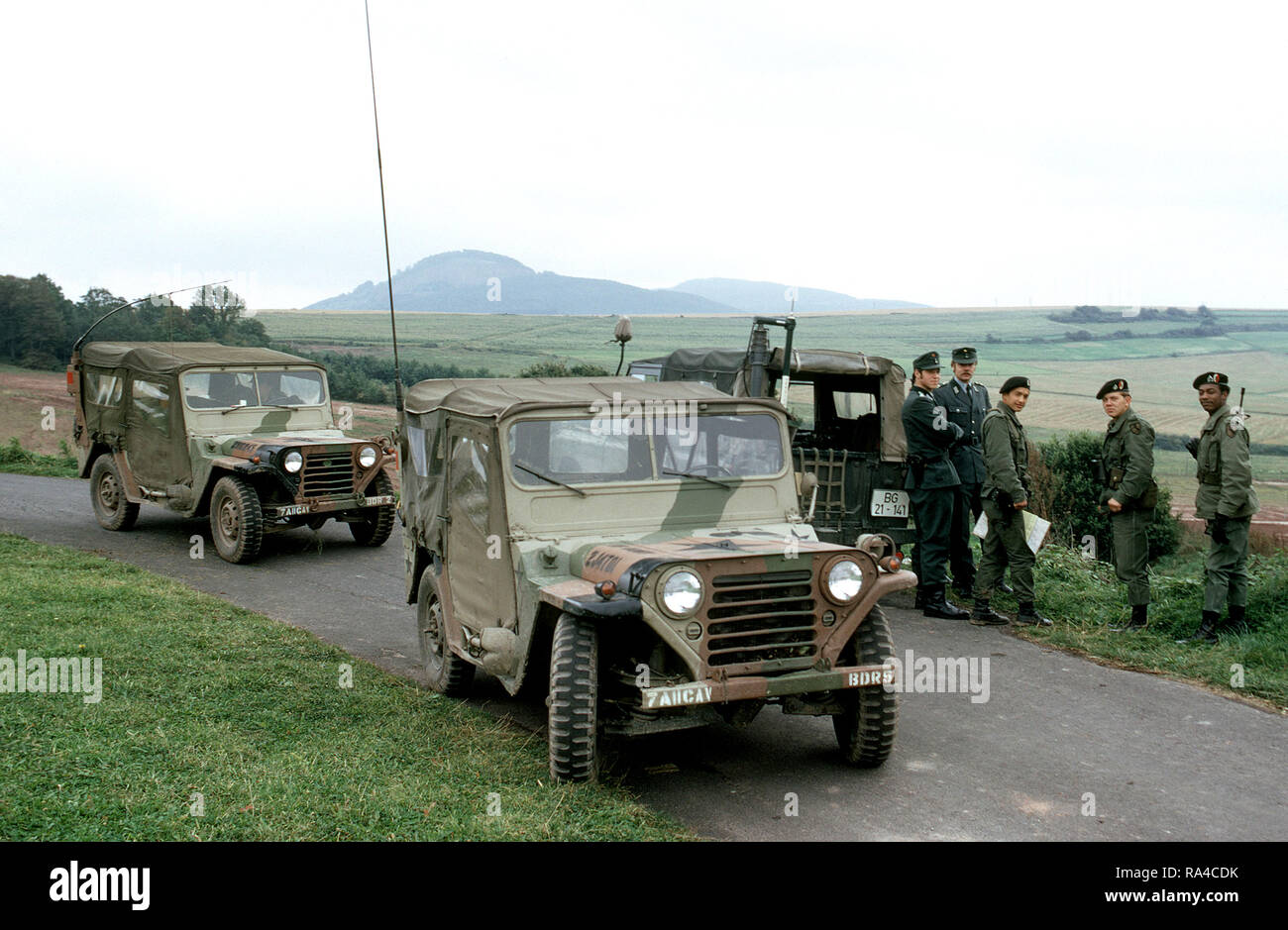 1979 - Members of the 11th Armored Cavalry stop to talk with West German soldiers while patrolling the border between East and West Germany in M151 light vehicles. Stock Photo