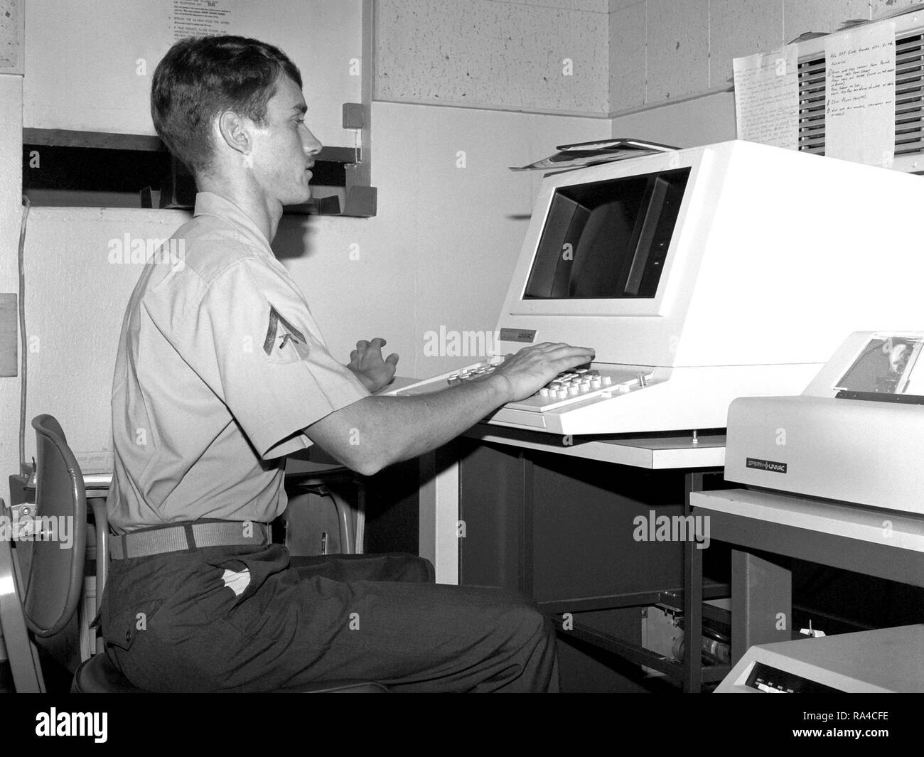 1979 - LCPL H.D. Sulger of the base communications center is processing a message on a Univac optical character reader so that the message can be transmitted to another military base. Stock Photo