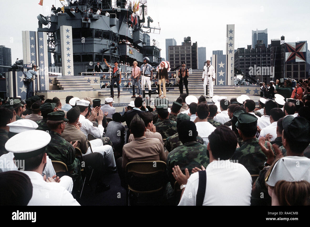 1979 - During the Bob Hope show aboard the amphibious assault ship USS IWO JIMA (LPH-2), the 'Village People' singing group sings 'YMCA'.  The ship and crew have just completed a field exercise in Puerto Rico. Stock Photo