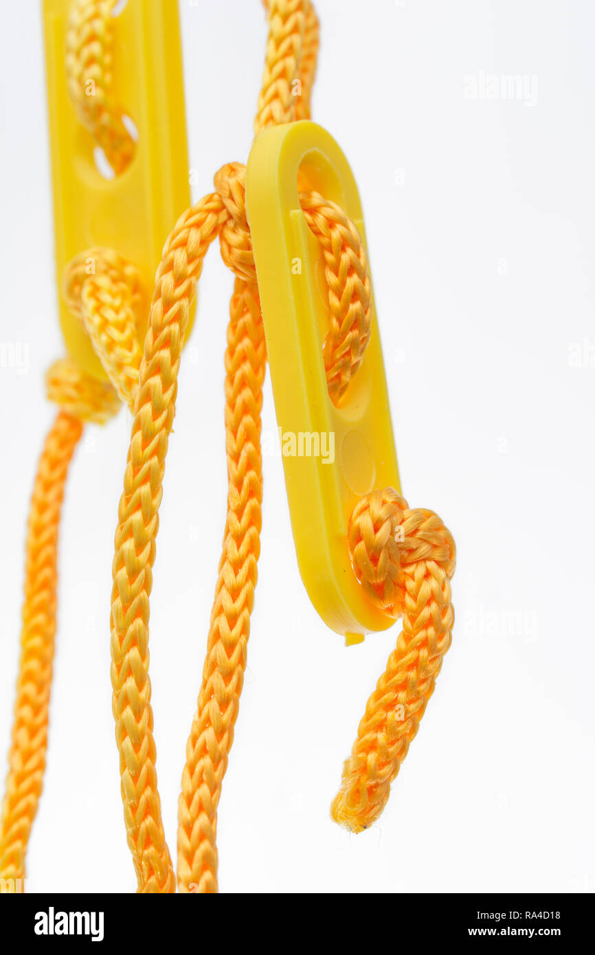 Bright orangeyellow tent guy lines with adjustable runner slider Stock Photo Alamy