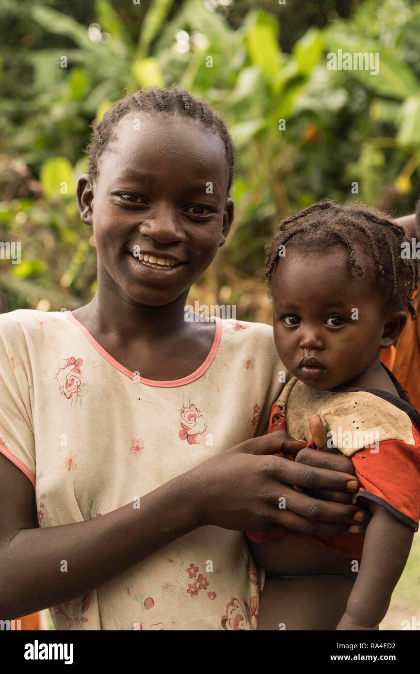 Girl holds toddler by arm, Ari tribe, Southern Nation Region, Ethiopia Stock Photo