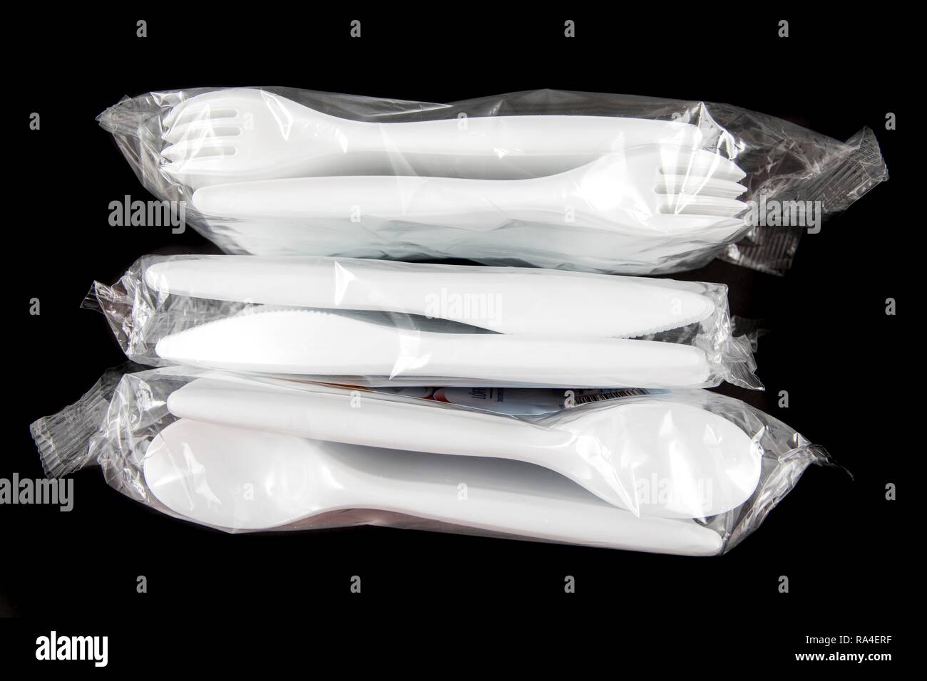 Large pack of plastic cutlery, disposable cutlery, knives, forks, spoons, plastic waste Stock Photo