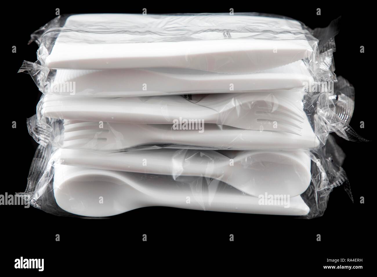 Large pack of plastic cutlery, disposable cutlery, knives, forks, spoons, plastic waste Stock Photo