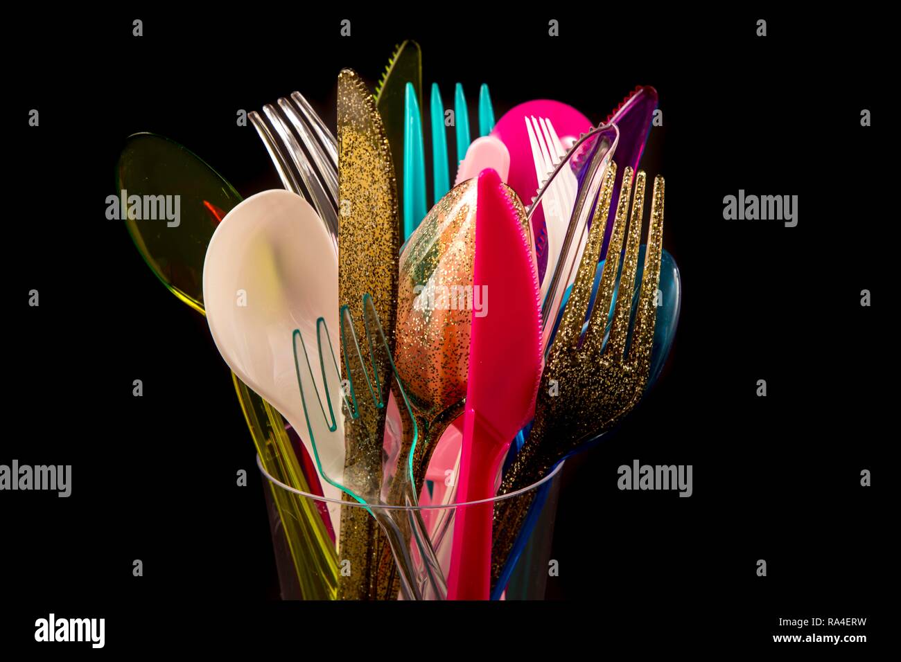 Plastic cutlery, disposable cutlery, knives, forks, spoons, plastic waste, various colours, types Stock Photo