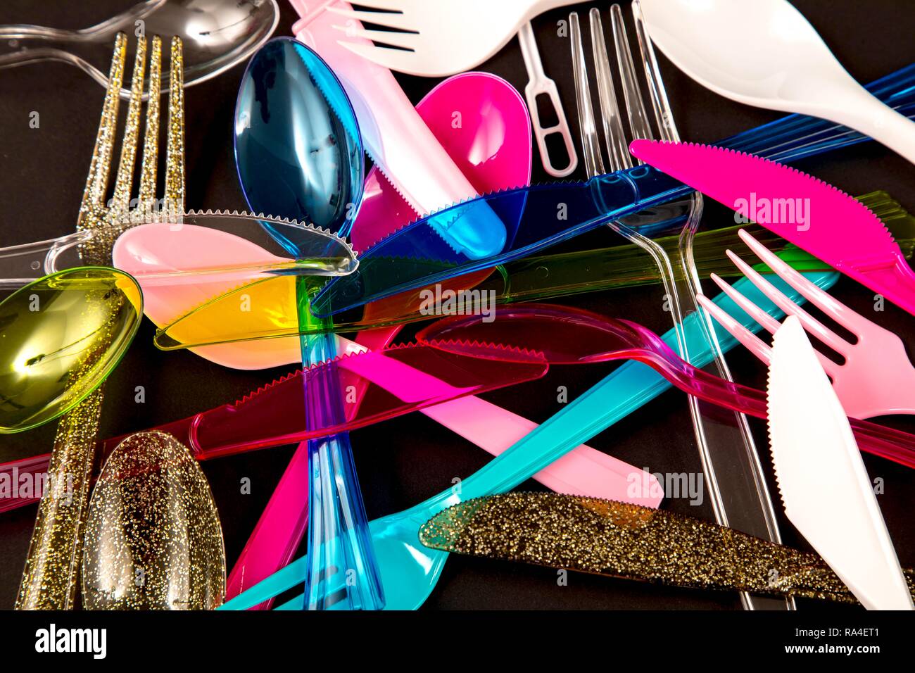 Plastic cutlery, disposable cutlery, knives, forks, spoons, plastic waste, various colours, types Stock Photo