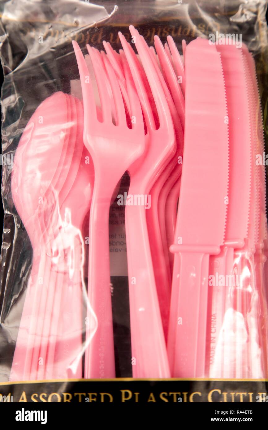 Plastic cutlery, disposable cutlery, knives, forks, spoons, plastic waste, transparent, pink Stock Photo
