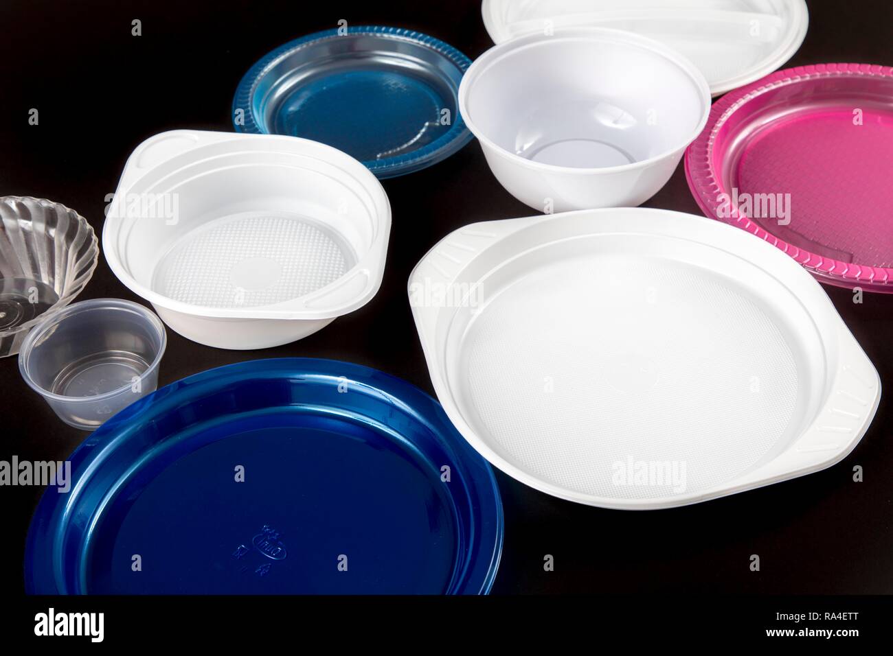 Plastic plates, plastic crockery, disposable crockery, plastic waste, various shapes and colors Stock Photo