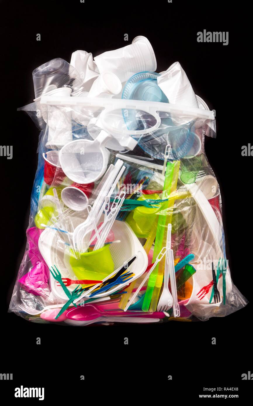 Garbage bag filled with disposable crockery, plastic cutlery, plastic crockery, plastic, plastic cups, plastic bags and other Stock Photo
