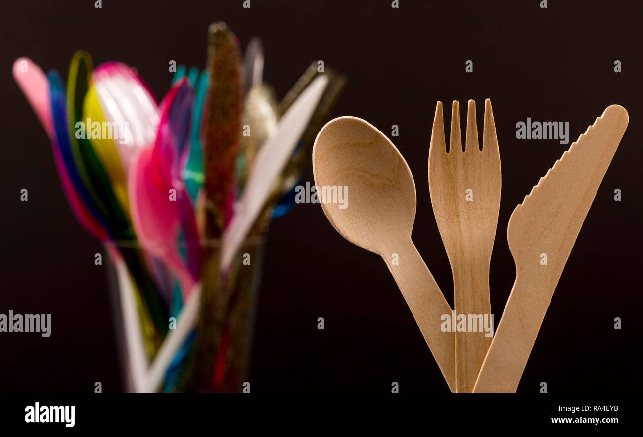 Disposable wooden cutlery, recyclable, plastic cutlery, disposable cutlery, knives, forks, spoons, plastic waste Stock Photo