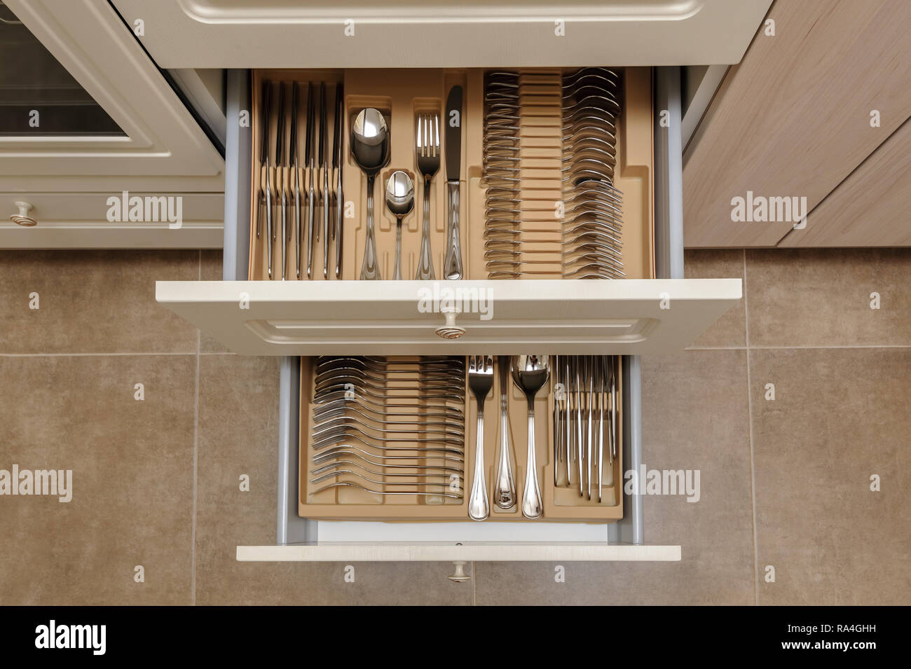 Opened kitchen drawers with silverware Stock Photo Alamy