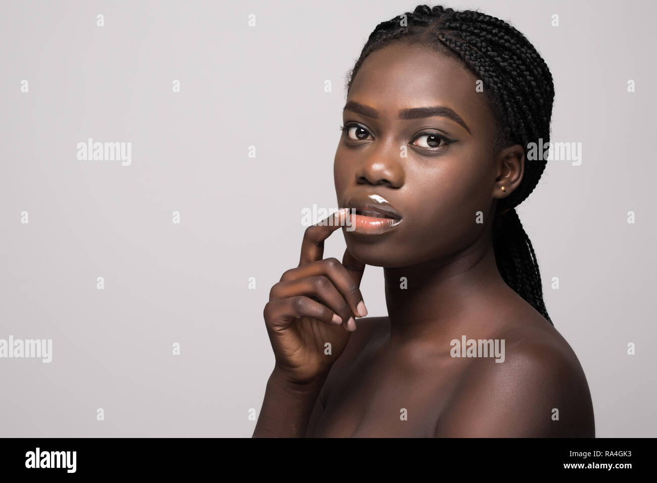 Beauty african woman face portrait. Beautiful afro american spa model girl with perfect fresh clean skin. Stock Photo