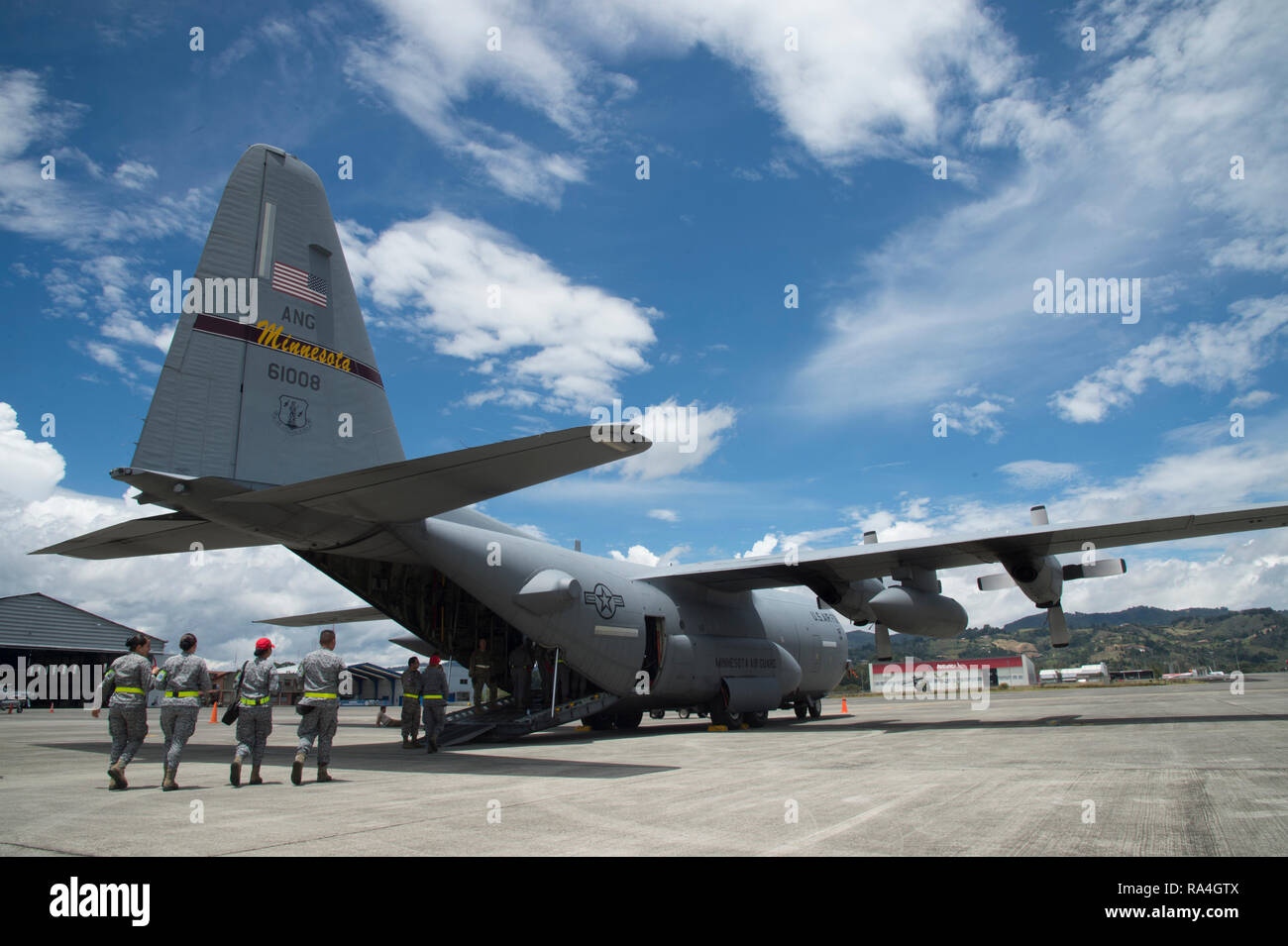 Colombian Air Force members walk onto a C-130 Hercules from the 133rd Airlift Squadron Minnesota Air National Guard at Air Combat Command number 5 at Arturo Lema Posada Air Base in Rionegro, Colombia, Sept. 4, 2018 as part of Angel de Los Andes. The two-week Colombian-led exercise has more than 400 participants from 12 nations. The first week of the exercise is focused on responding to natural disaster scenarios that include an earthquake response, a forest fire and an open water rescue, as well as, responding to an aircraft crash. (U.S. Air Force photo by Tech. Sgt. Angela Ruiz) Stock Photo