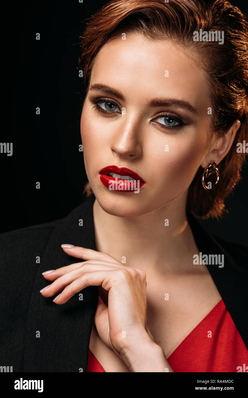 portrait of beautiful woman in red dress and black jacket looking at ...