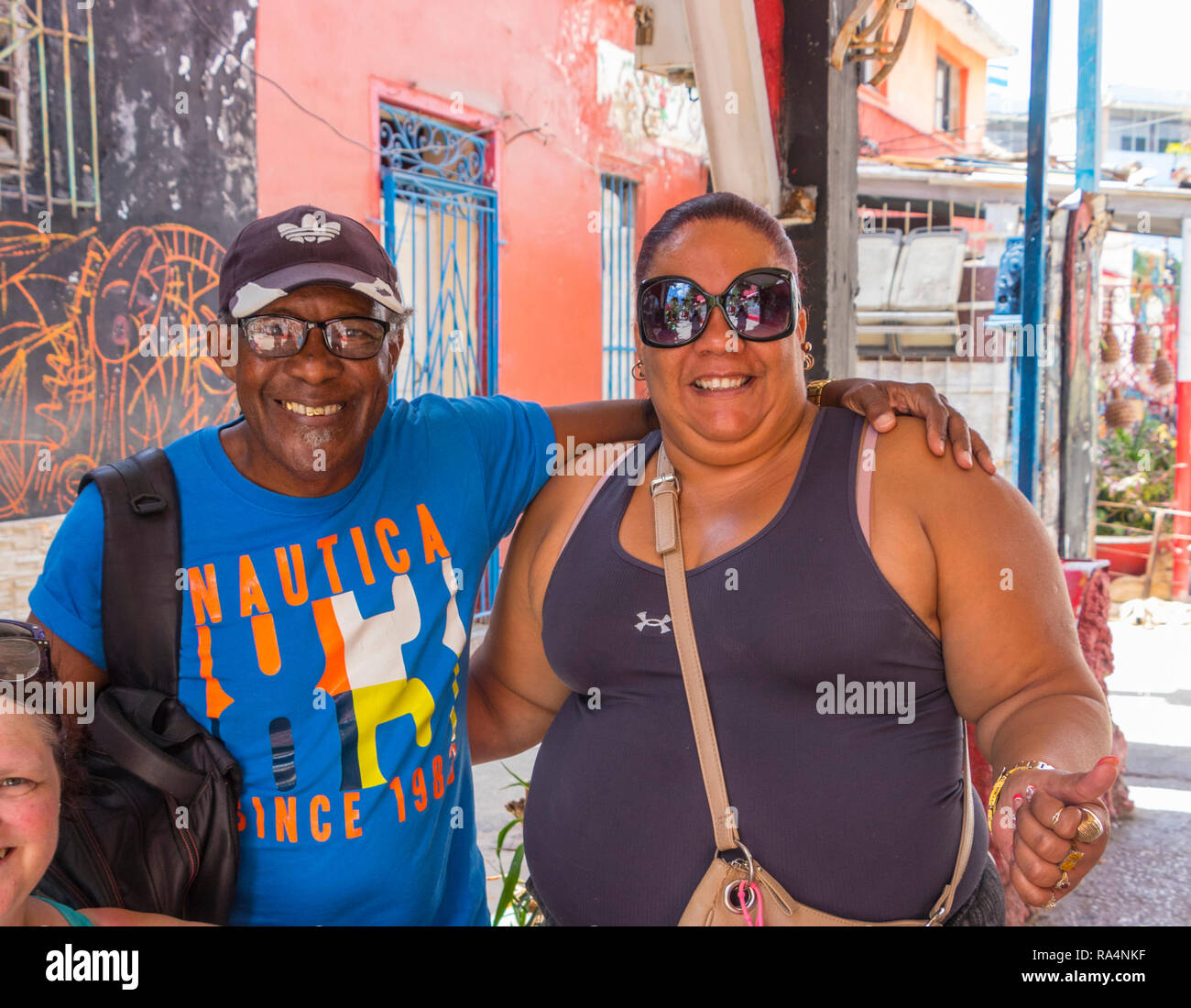 middle aged latin couple smile and embrace in a cuban street in havana cuba Stock Photo