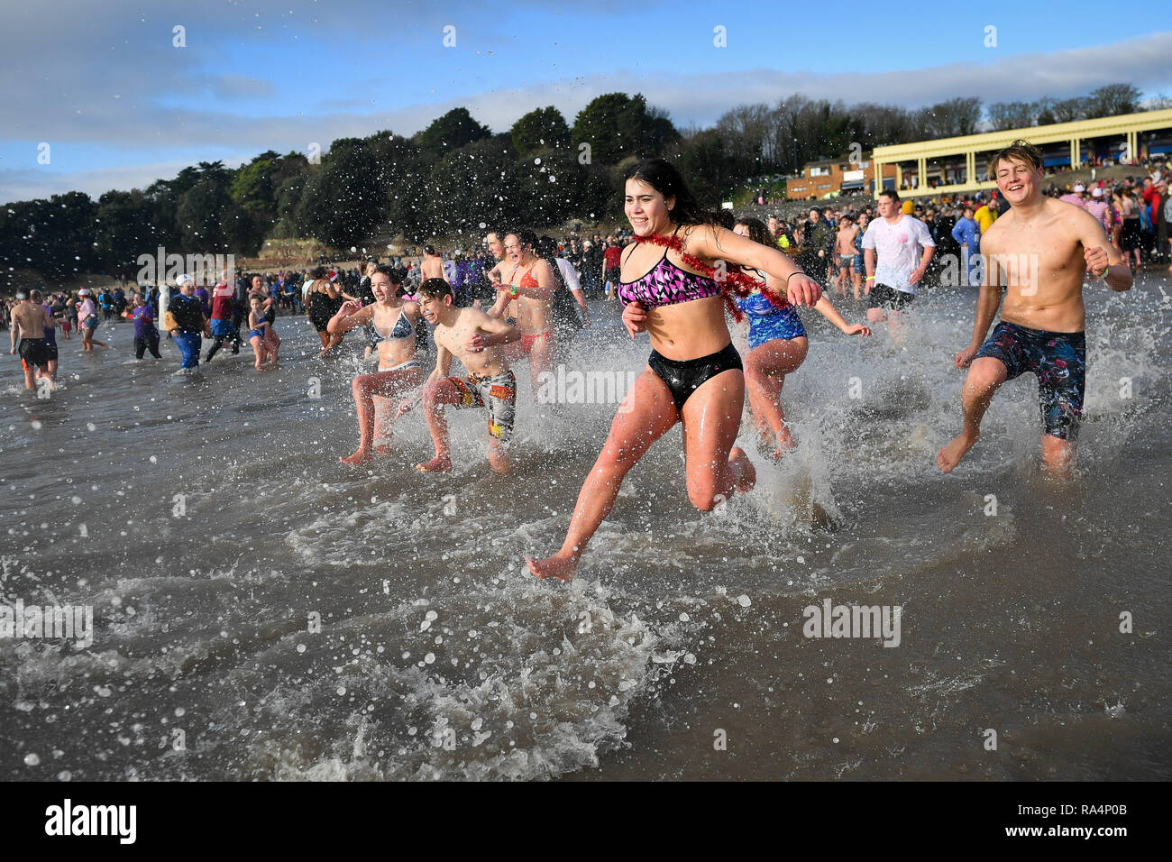 People take part in the Barry Island New Year's Day swim in Barry, Vale of  Glamorgan, Wales Stock Photo - Alamy