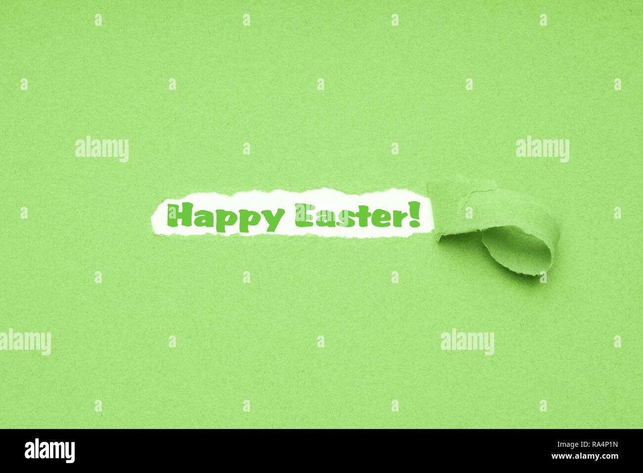 hole torn in green paper background to reveal Happy Easter greeting Stock Photo
