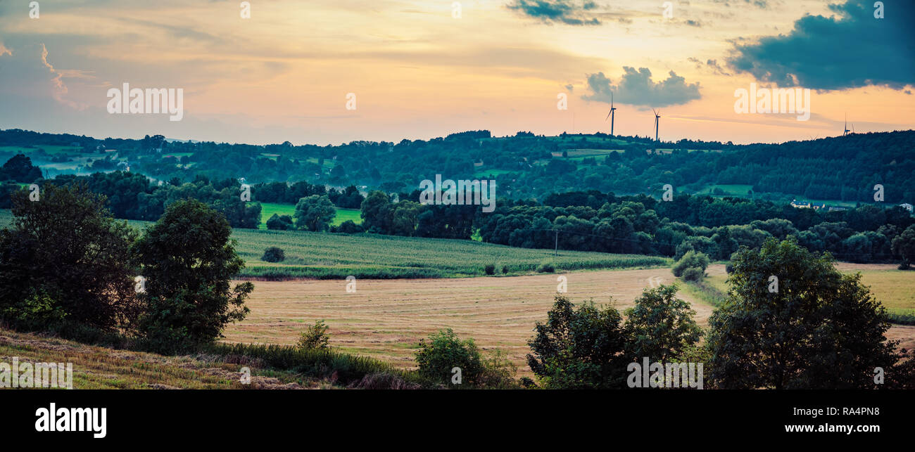 Wind turbines on sunset background, Romania Stock Photo